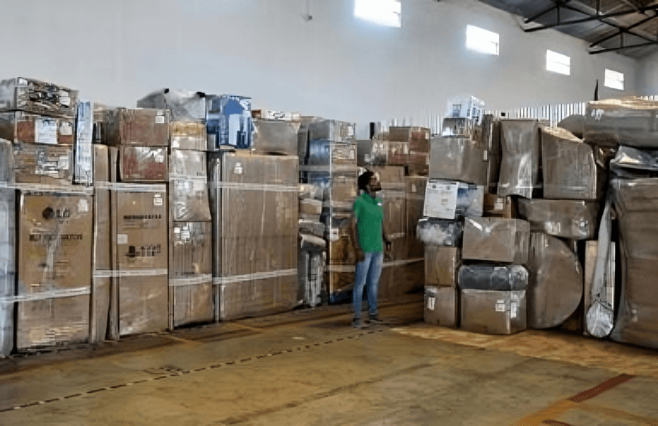 Household boxes stacked and labelled in a storage bay